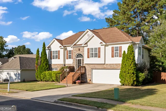 a front view of a house with a garden
