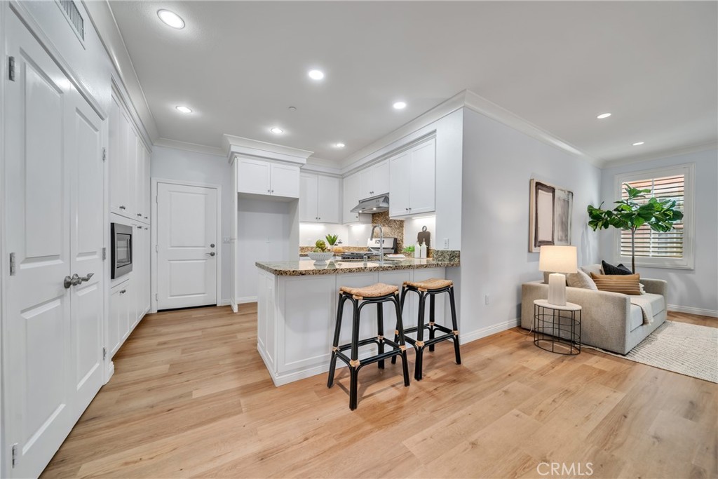 113 Mayfair Irvine, CA 92620 - Photo 11 of 31 a living room with furniture and a wooden floor
