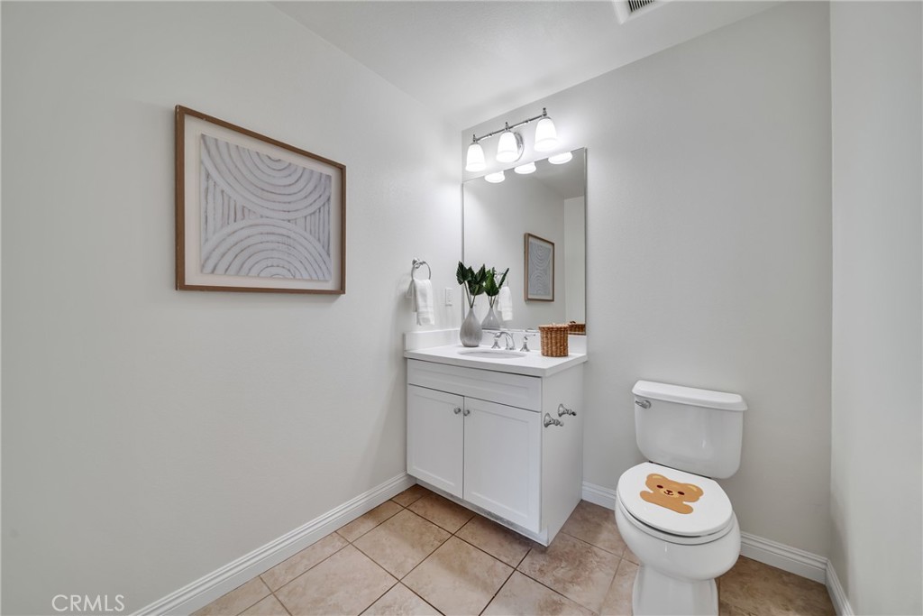 113 Mayfair Irvine, CA 92620 - Photo 17 of 31 a bathroom with a toilet sink and mirror