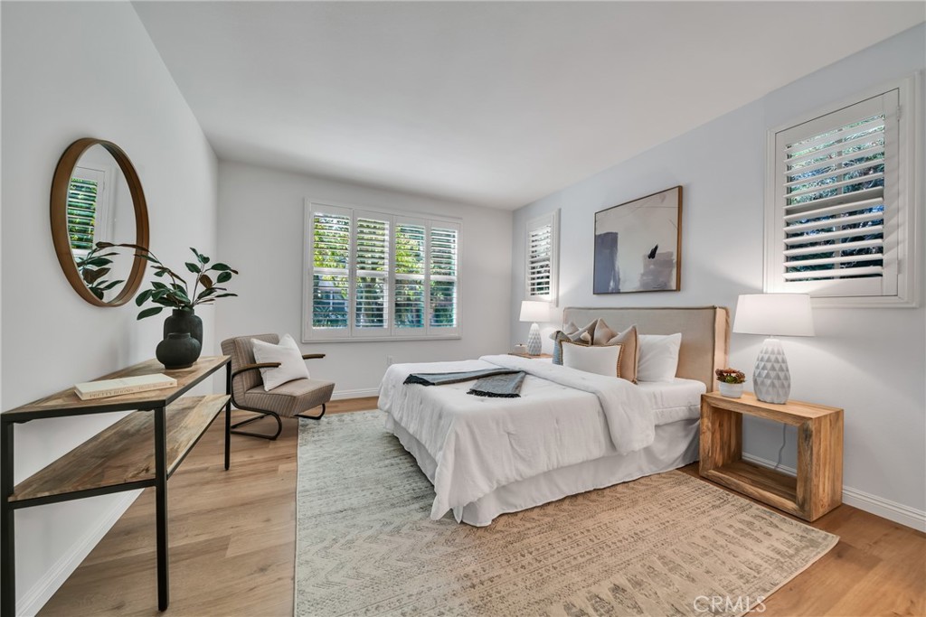 113 Mayfair Irvine, CA 92620 - Photo 18 of 31 a bed room with a bed and a chandelier