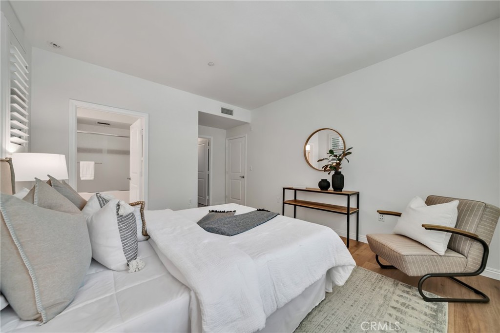 113 Mayfair Irvine, CA 92620 - Photo 20 of 31 a bedroom with a bed and chandelier