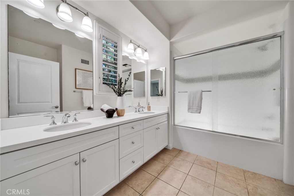 113 Mayfair Irvine, CA 92620 - Photo 21 of 31 a bathroom with a double vanity sink mirror and