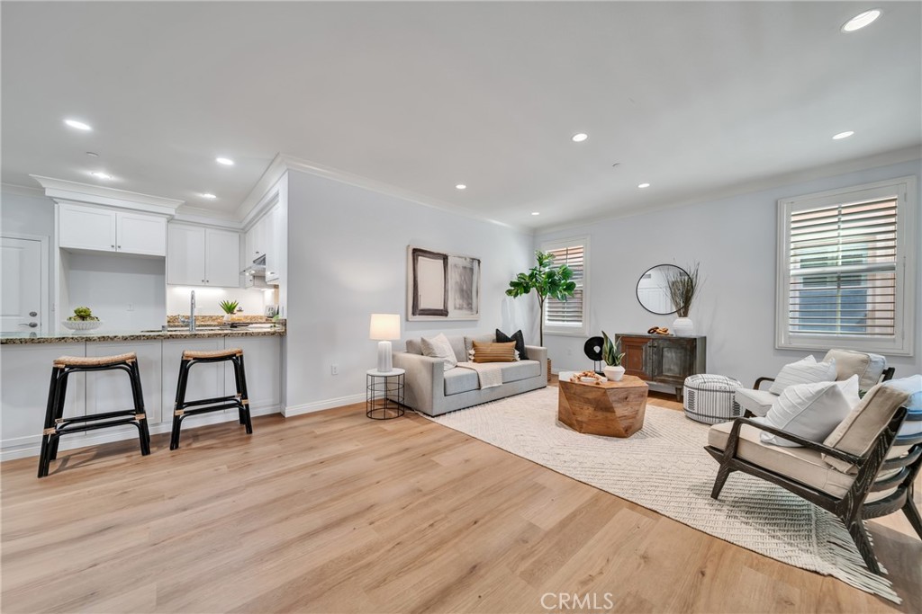 113 Mayfair Irvine, CA 92620 - Photo 6 of 31 a living room with furniture and a wooden floor