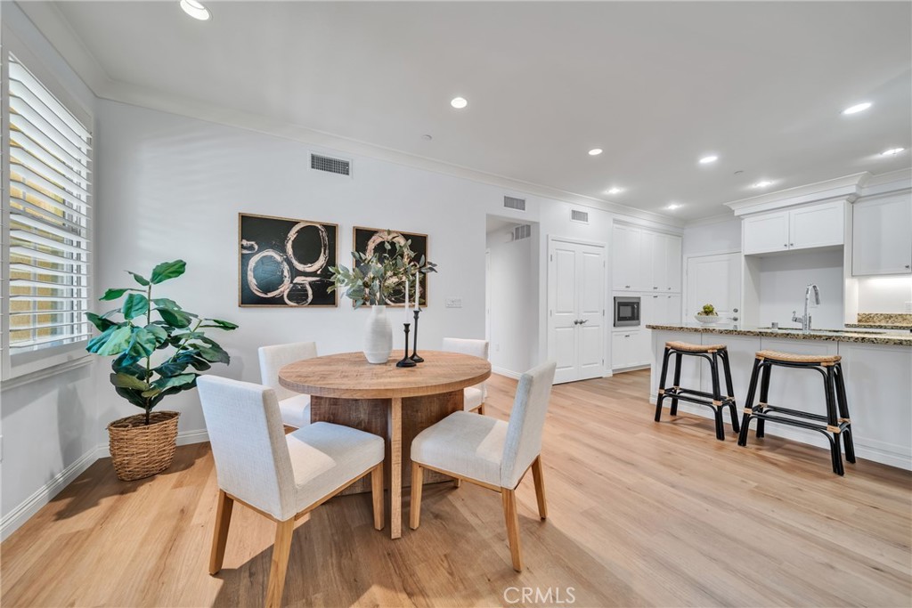 113 Mayfair Irvine, CA 92620 - Photo 9 of 31 a view of a dining room with furniture and wooden floor