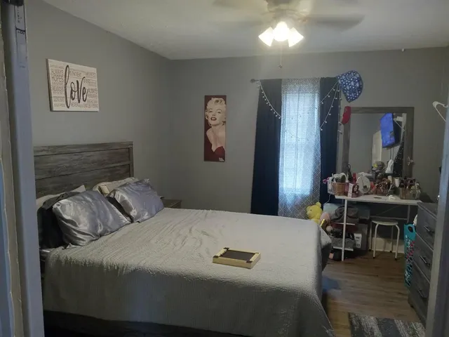 a bedroom that has a bed and a table in it