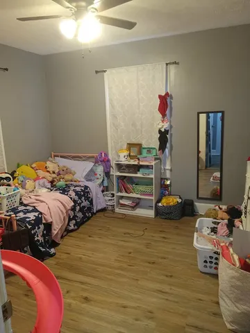 a bedroom with two beds and a chandelier