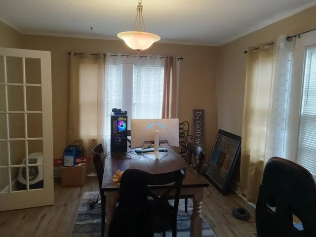 a view of a workspace with furniture and a window