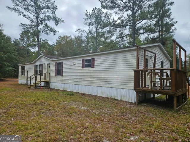 a view of a house with wooden fence