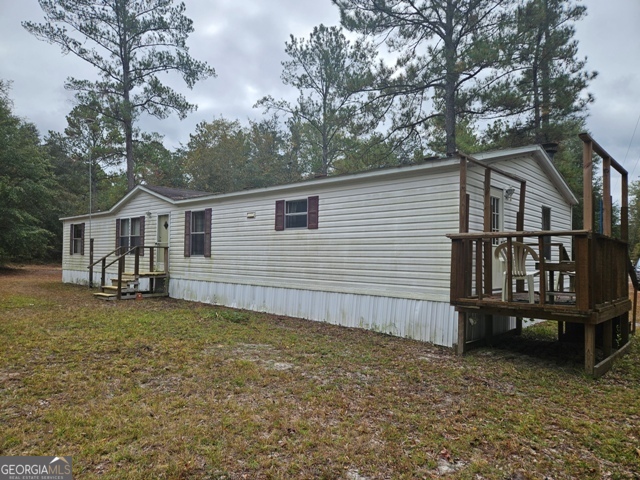 a view of a house with wooden fence
