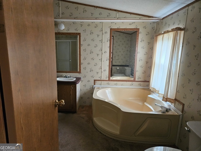 1377 Hillside Drive Claxton, GA 30417 - Photo 11 of 24 a bathroom with a tub and a sink