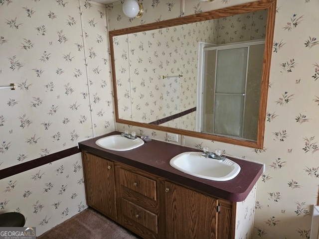 1377 Hillside Drive Claxton, GA 30417 - Photo 13 of 24 a bathroom with a sink and a mirror