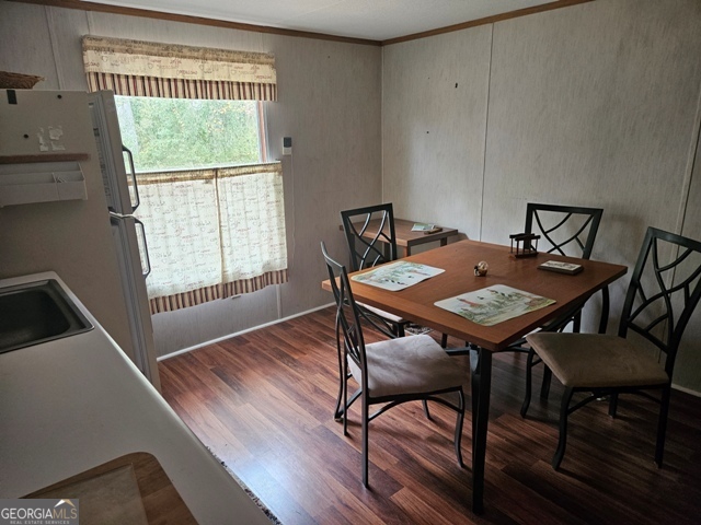 1377 Hillside Drive Claxton, GA 30417 - Photo 16 of 24 a view of a dining room with furniture window and wooden floor