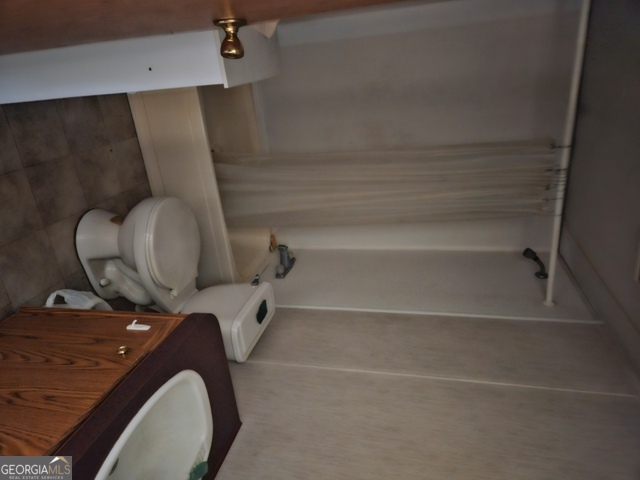 1377 Hillside Drive Claxton, GA 30417 - Photo 20 of 24 a bathroom with a toilet and a vanity
