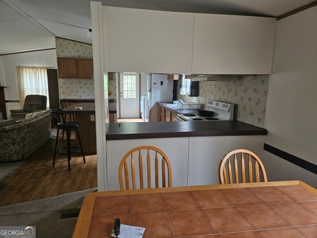 1377 Hillside Drive Claxton, GA 30417 - Photo 5 of 24 a view of a livingroom with furniture flat screen tv and outdoor view