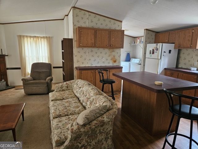 1377 Hillside Drive Claxton, GA 30417 - Photo 8 of 24 a living room with furniture and a refrigerator