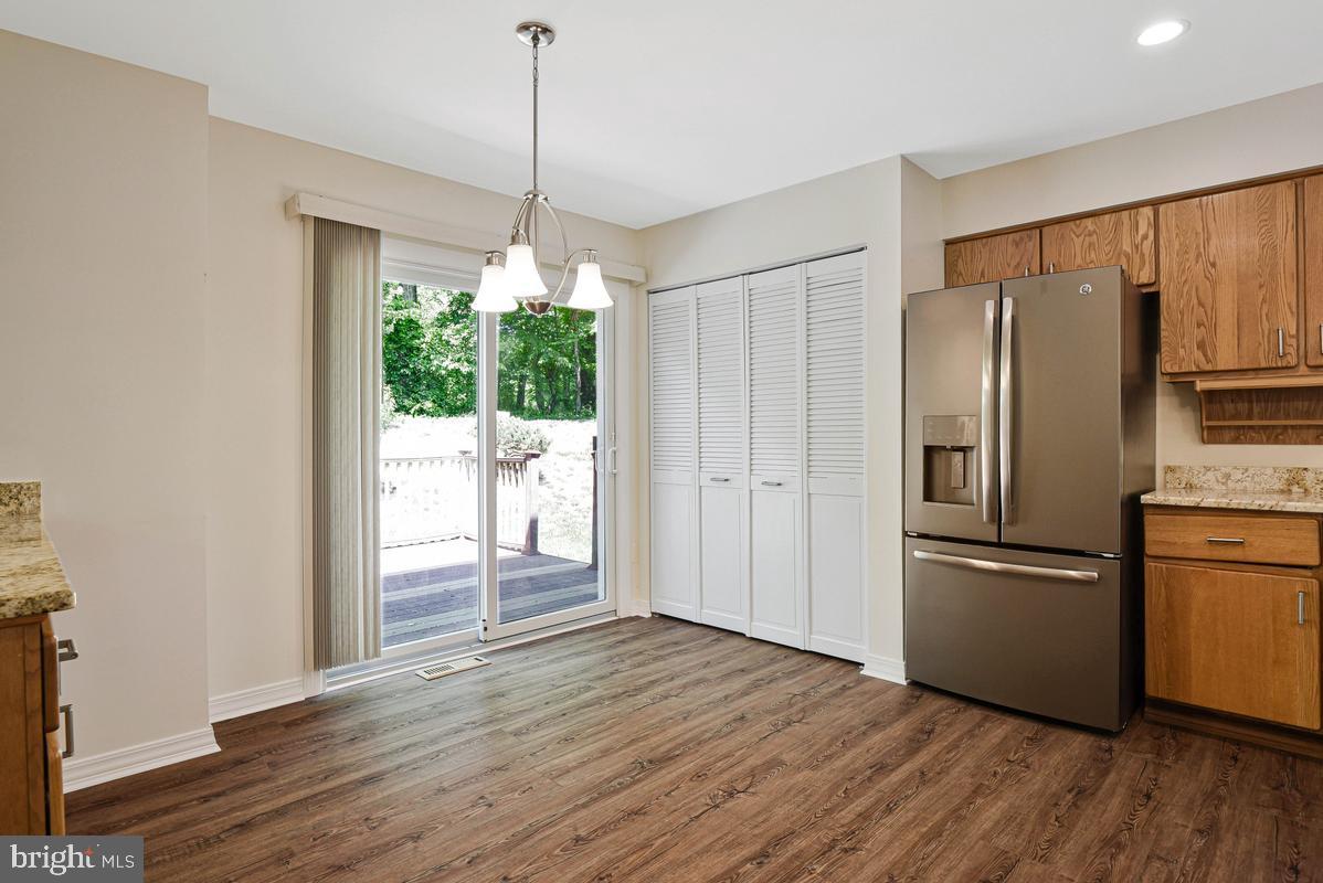 11814 Blue Spruce Road Reston, VA 20191 - Photo 12 of 56 a kitchen with stainless steel appliances granite countertop a refrigerator a sink and a stove