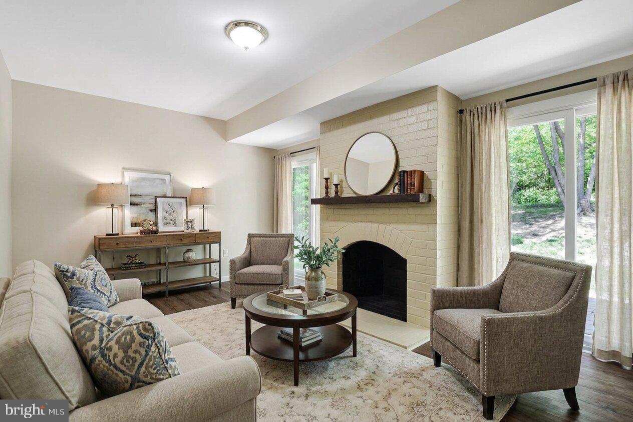 11814 Blue Spruce Road Reston, VA 20191 - Photo 17 of 56 a living room with furniture and a fireplace