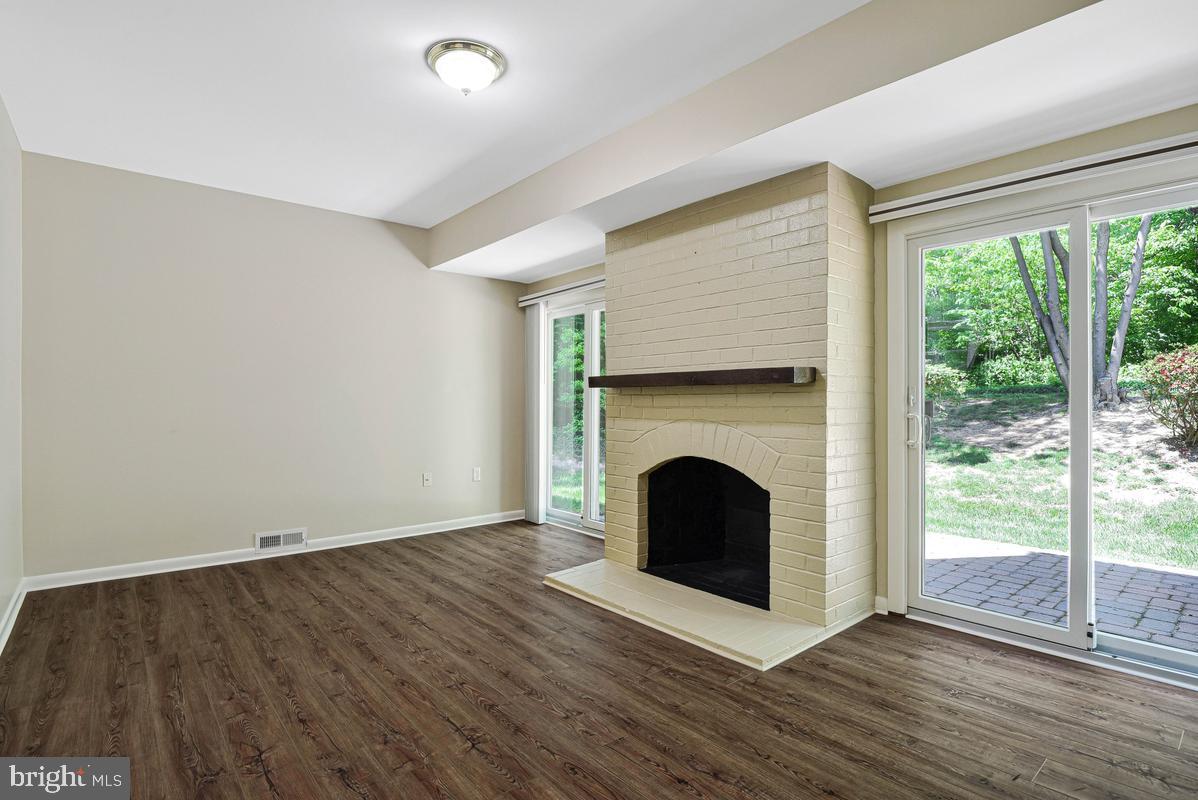 11814 Blue Spruce Road Reston, VA 20191 - Photo 18 of 56 a view of an empty room with wooden floor and a window