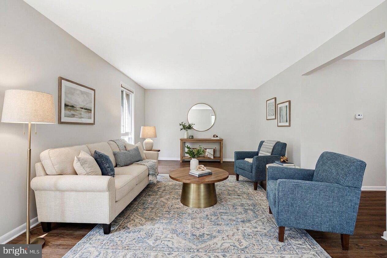 11814 Blue Spruce Road Reston, VA 20191 - Photo 19 of 56 a living room with furniture a rug and a lamp