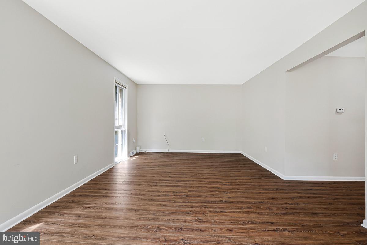 11814 Blue Spruce Road Reston, VA 20191 - Photo 20 of 56 a view of an empty room with wooden floor