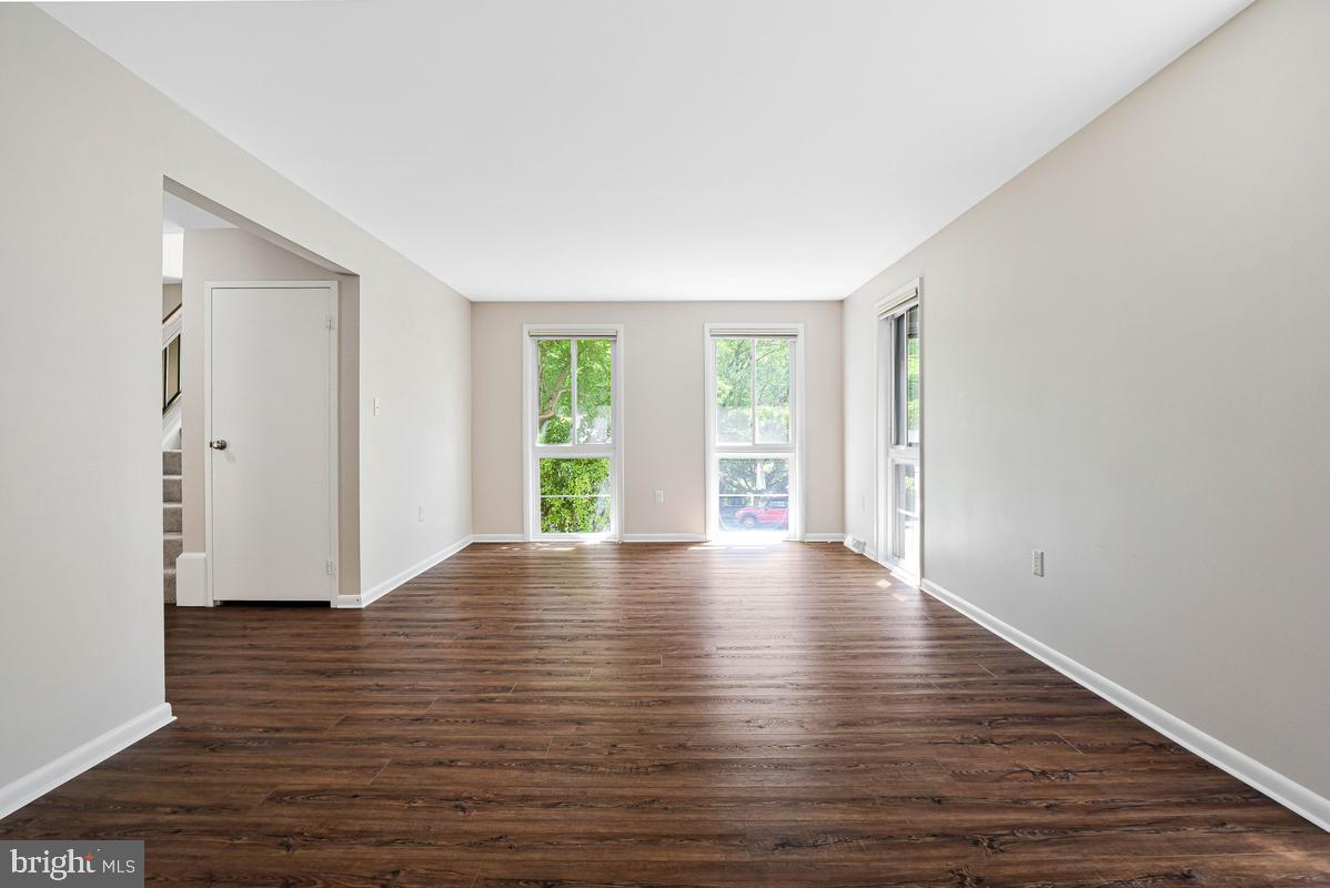 11814 Blue Spruce Road Reston, VA 20191 - Photo 21 of 56 a view of an empty room with wooden floor and a window