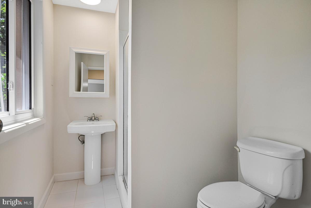 11814 Blue Spruce Road Reston, VA 20191 - Photo 27 of 56 a white toilet sitting next to a bathroom sink
