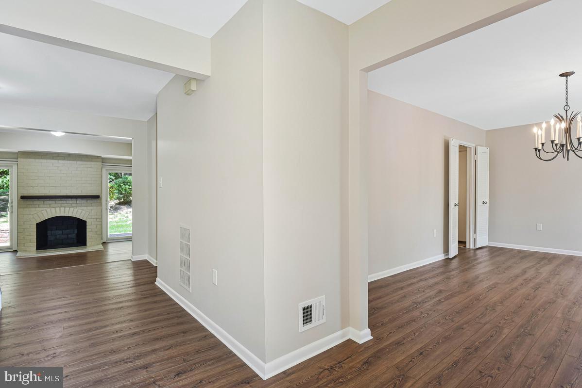 11814 Blue Spruce Road Reston, VA 20191 - Photo 3 of 56 a view of a livingroom with wooden floor and a fireplace