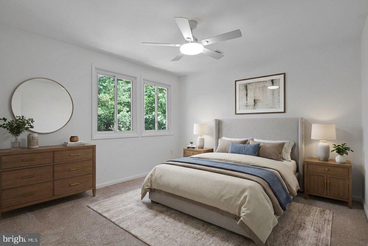 11814 Blue Spruce Road Reston, VA 20191 - Photo 35 of 56 a bedroom with a large bed and a chandelier
