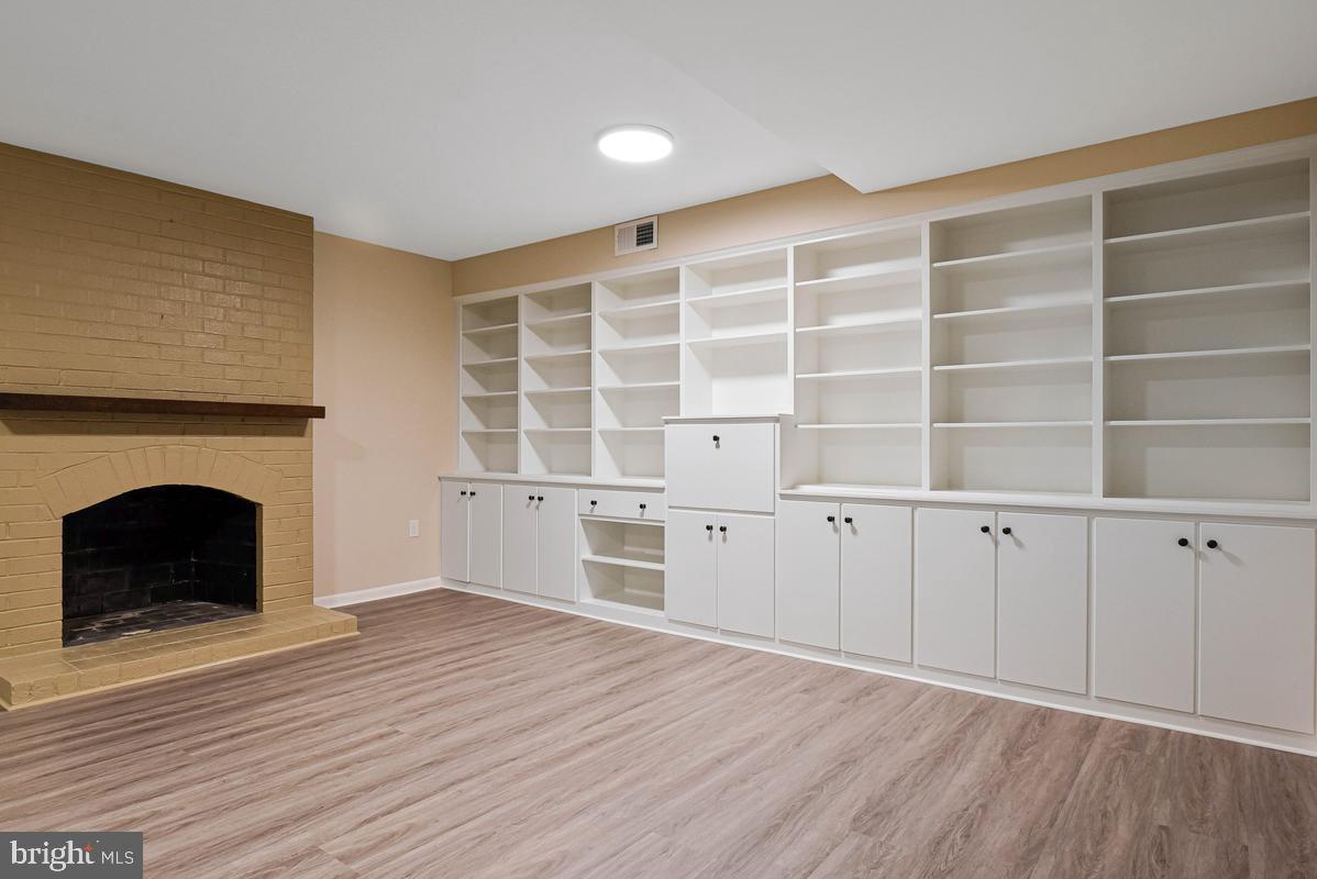 11814 Blue Spruce Road Reston, VA 20191 - Photo 41 of 56 a view of an empty room with a fireplace and a window