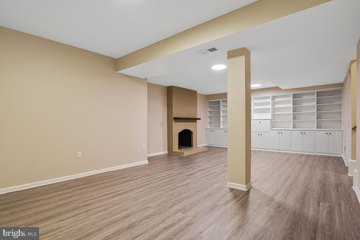 11814 Blue Spruce Road Reston, VA 20191 - Photo 44 of 56 wooden floor in an empty room with a fireplace