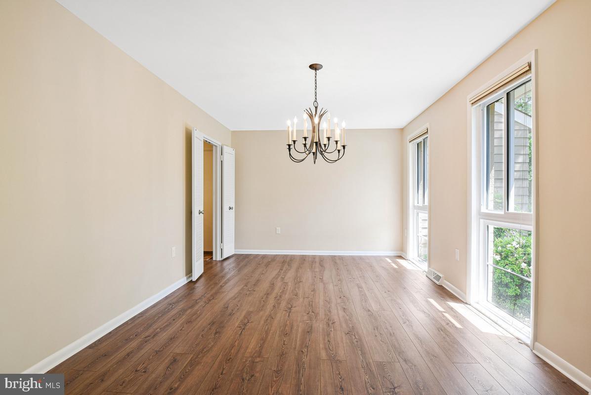 11814 Blue Spruce Road Reston, VA 20191 - Photo 5 of 56 a view of an empty room with wooden floor and a window