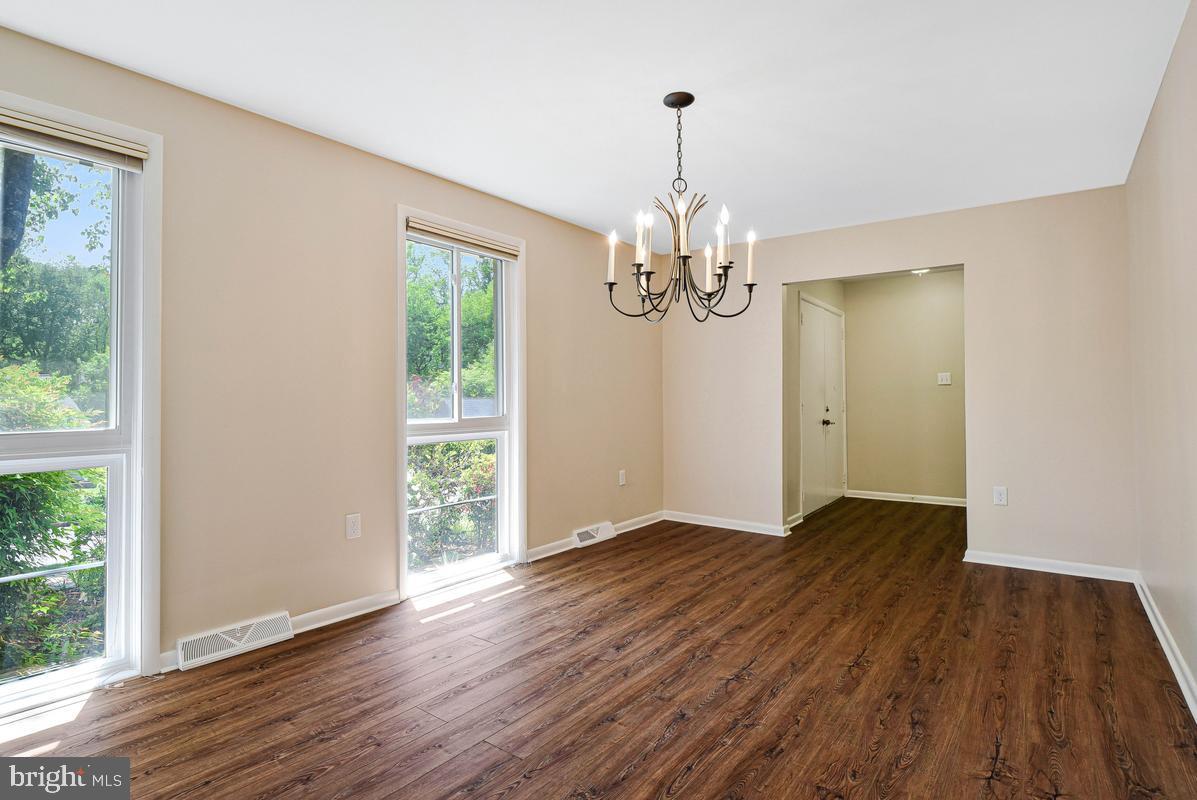 11814 Blue Spruce Road Reston, VA 20191 - Photo 6 of 56 a view of an empty room with wooden floor and a window