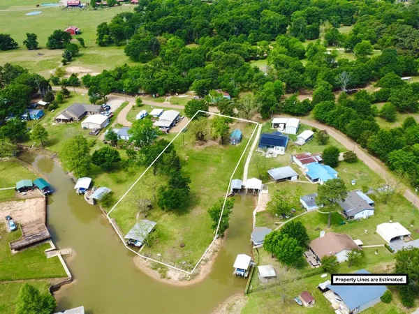 an aerial view of a residential houses with yard