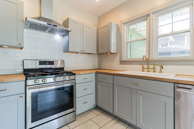 1616 West Church Street Champaign, IL 61821 - Photo 13 of 32 a kitchen with cabinets appliances and a sink