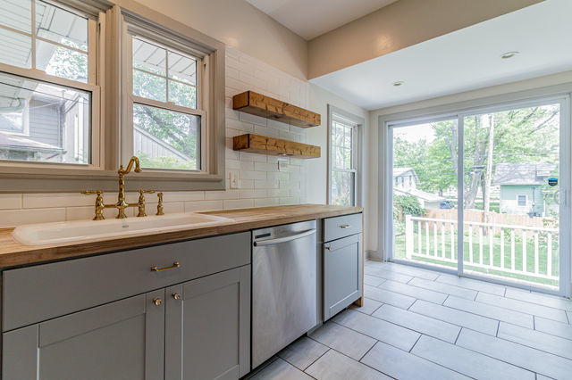 1616 West Church Street Champaign, IL 61821 - Photo 14 of 32 a spacious bathroom with a double vanity sink a mirror and next to a window