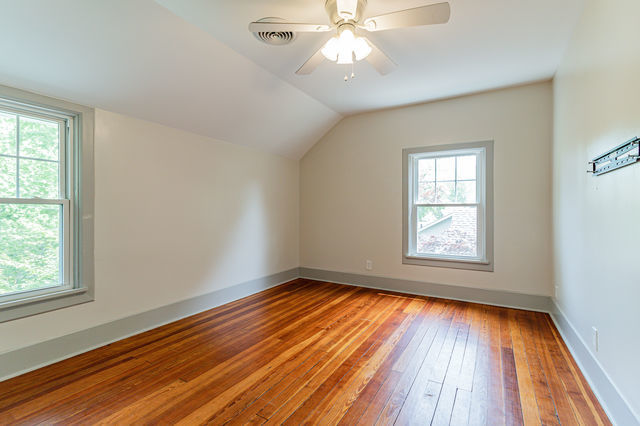 1616 West Church Street Champaign, IL 61821 - Photo 17 of 32 an empty room with wooden floor closet and windows