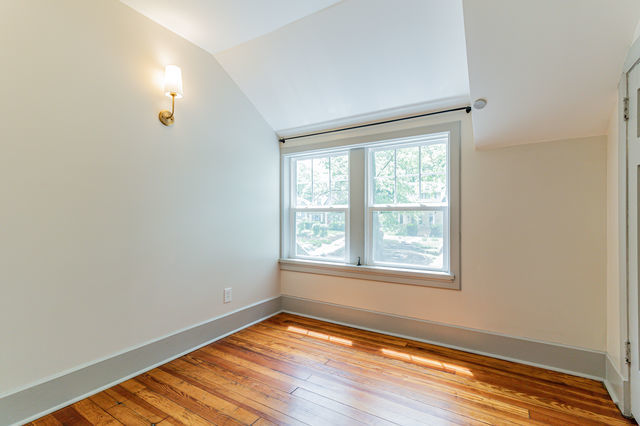1616 West Church Street Champaign, IL 61821 - Photo 18 of 32 an empty room with wooden floor and windows