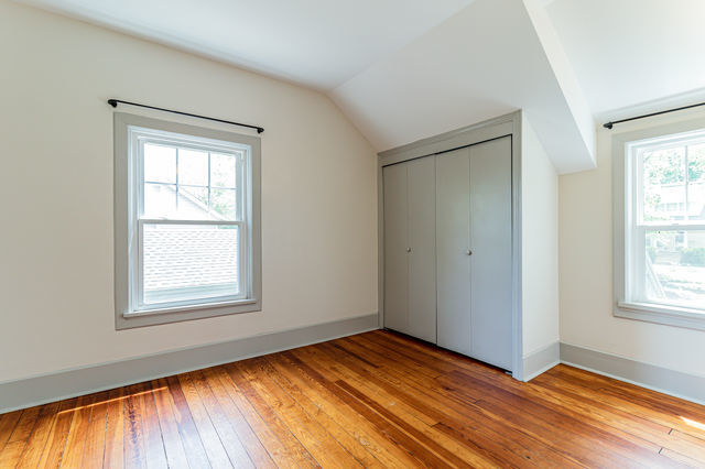 1616 West Church Street Champaign, IL 61821 - Photo 20 of 32 a view of an empty room with wooden floor and a window