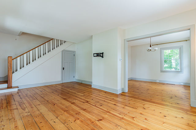 1616 West Church Street Champaign, IL 61821 - Photo 5 of 32 a view of an empty room with wooden floor and a window