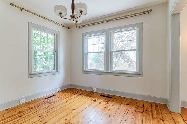 1616 West Church Street Champaign, IL 61821 - Photo 7 of 32 a view of empty room with wooden floor and fan