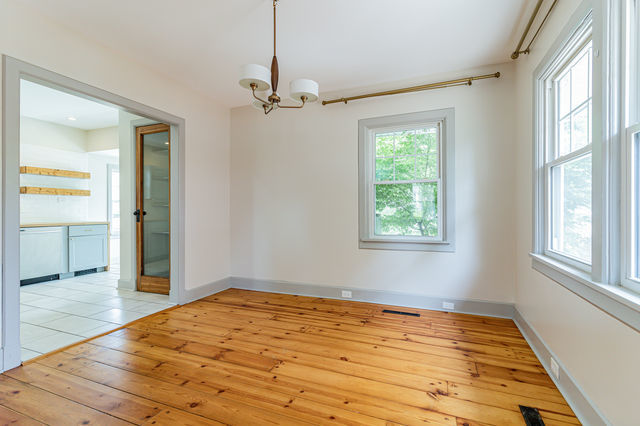 1616 West Church Street Champaign, IL 61821 - Photo 8 of 32 a view of empty room with wooden floor and fan