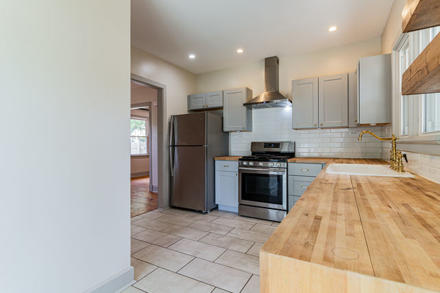 1616 West Church Street Champaign, IL 61821 - Photo 10 of 32 a kitchen with a refrigerator and a stove