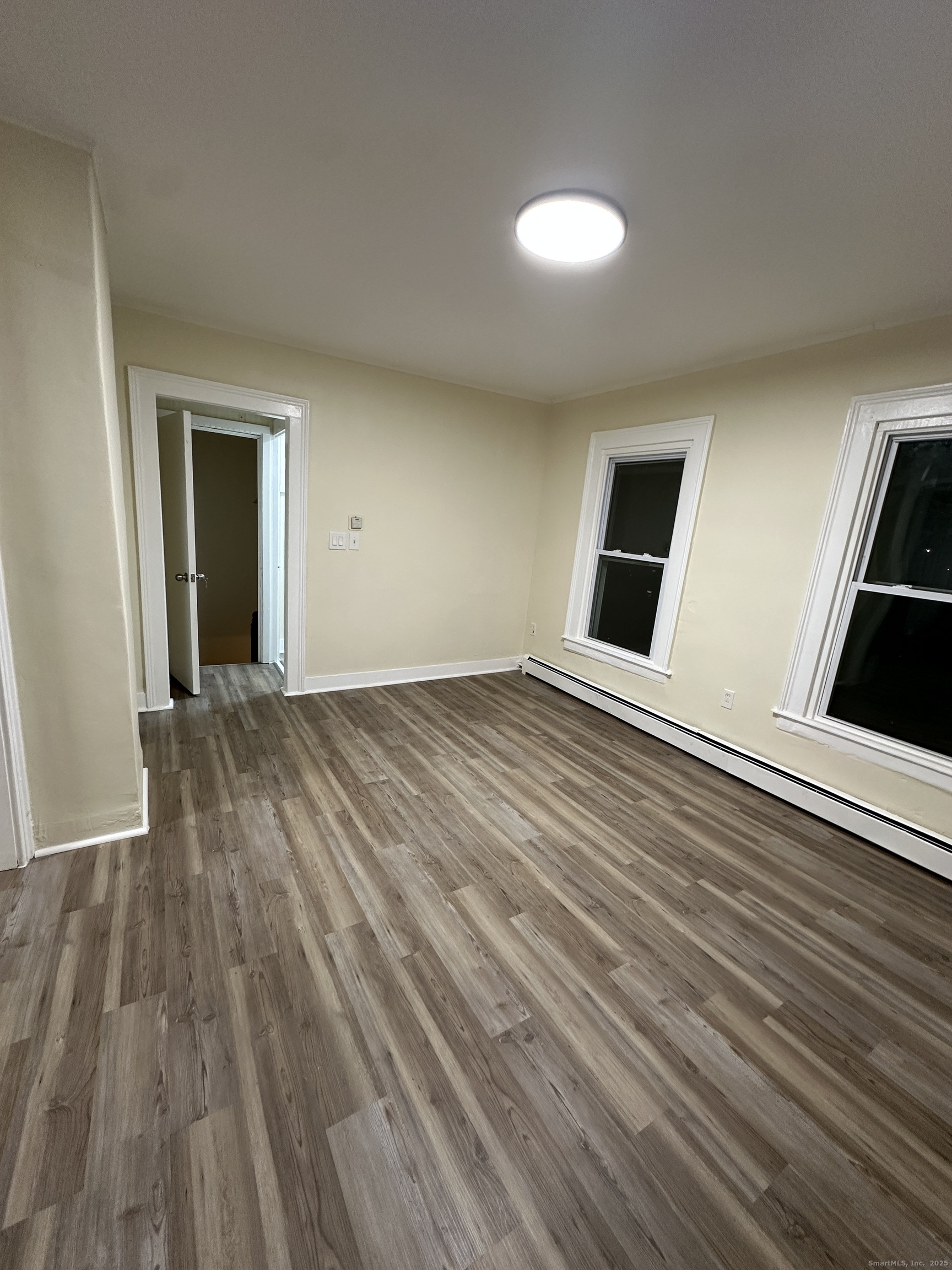 42 Spring Street New London, CT 06320 - Photo 2 of 10 wooden floor in an empty room with a window