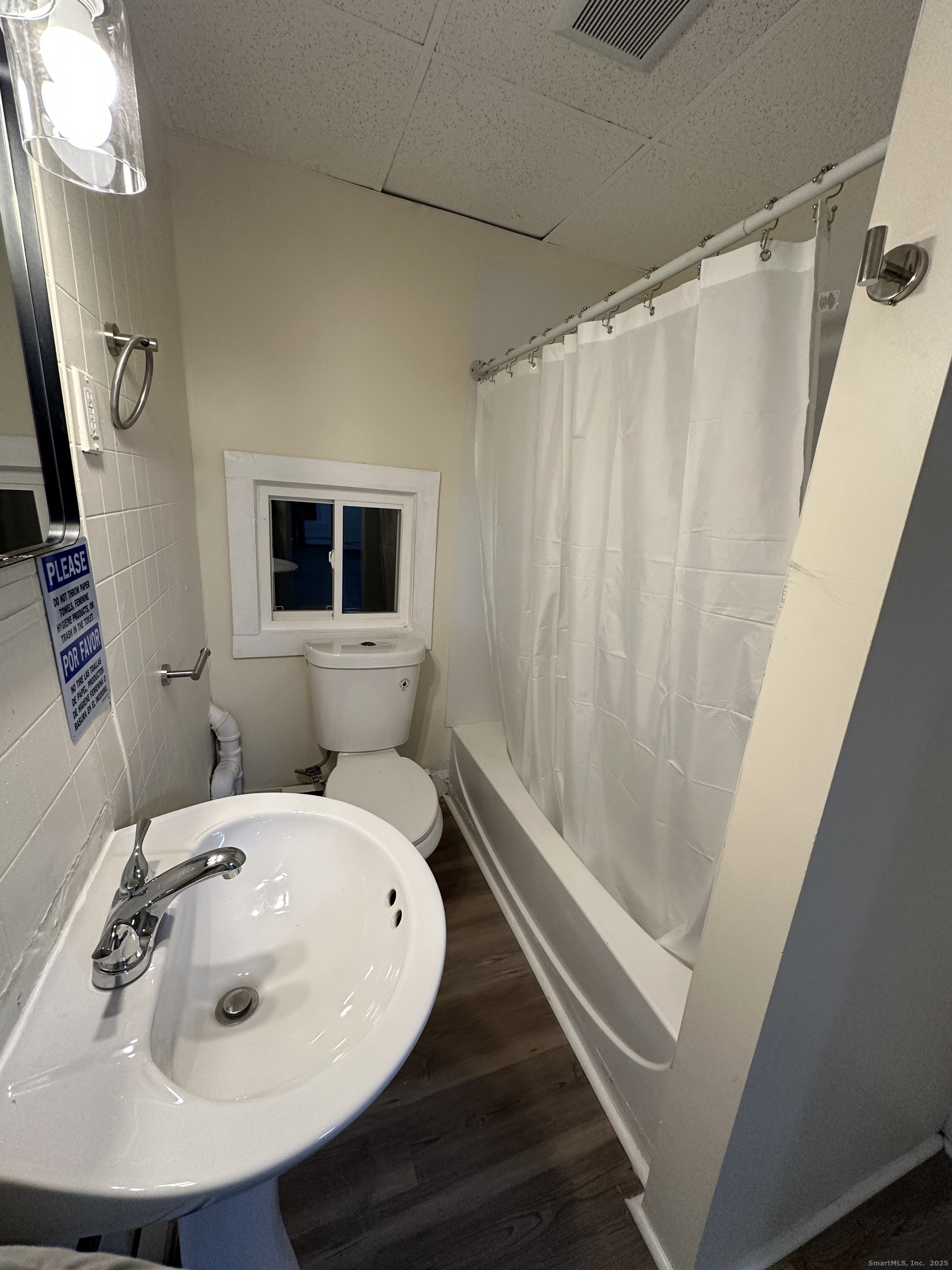 42 Spring Street New London, CT 06320 - Photo 7 of 10 a bathroom with a sink a mirror and a shower