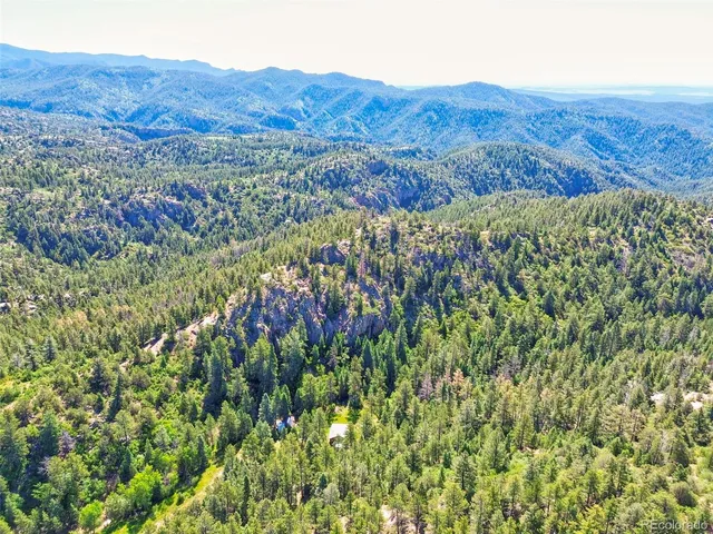 a view of a house with backyard sitting area and garden