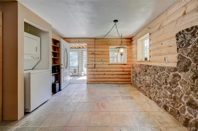 a room with gym equipment and a view of living room
