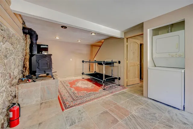 a living room with a rug and a flat screen tv