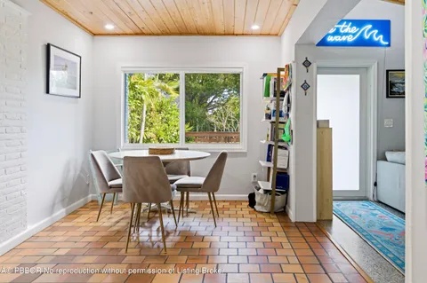 a dining room with furniture and a window