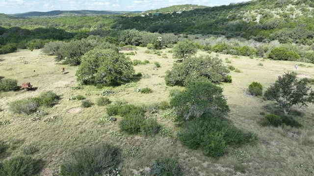 an aerial view of a house with a yard