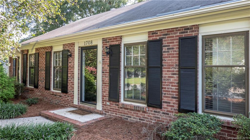 1708 Lawton Bluff Road Charlotte, NC 28226 - Photo 2 of 25 a front view of a house with a plants and glass door